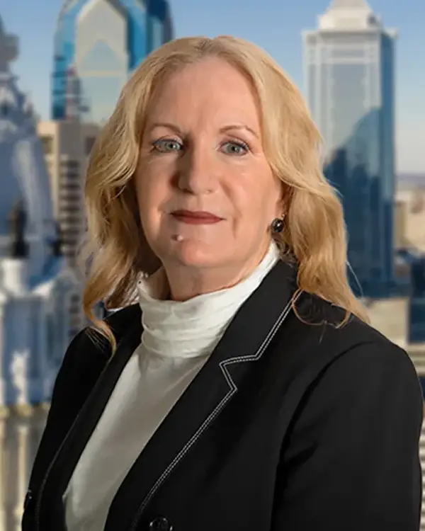 Karen Greene-Malos in front of aerial view of city